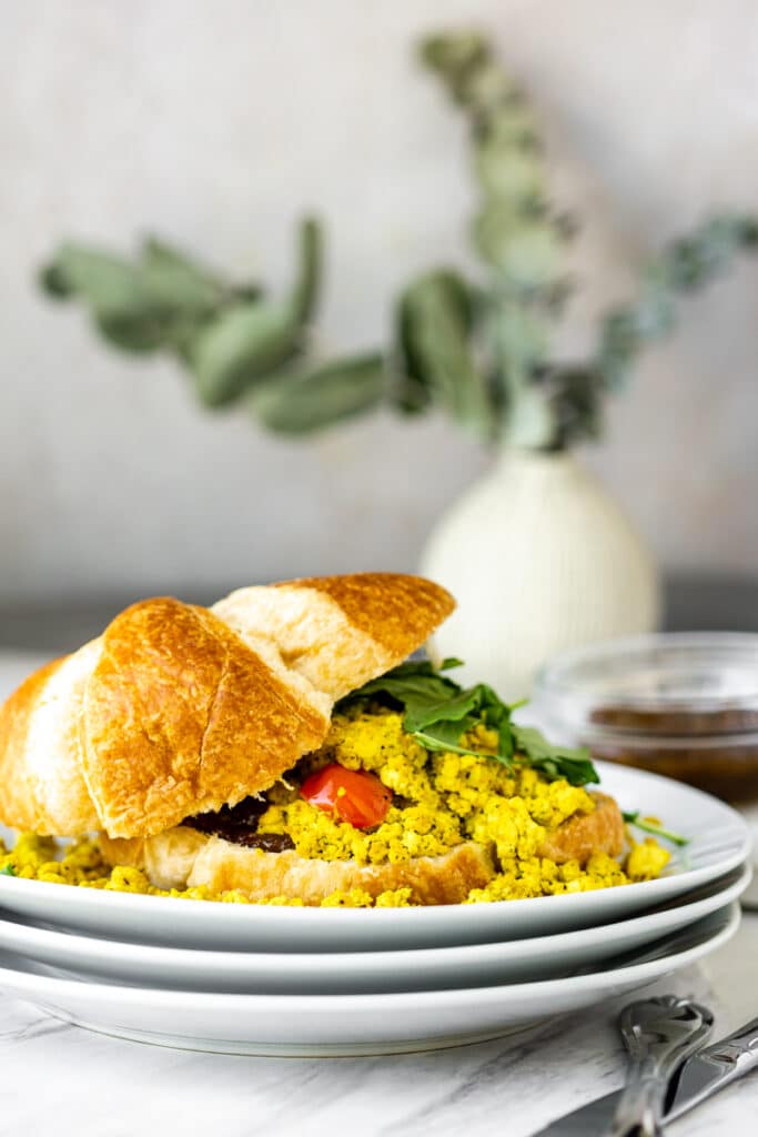 tofu scramble with tomatoes, spinach, vegan croissant, and fig preserve